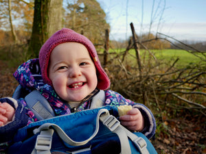 a happle baby wearing a purple coat